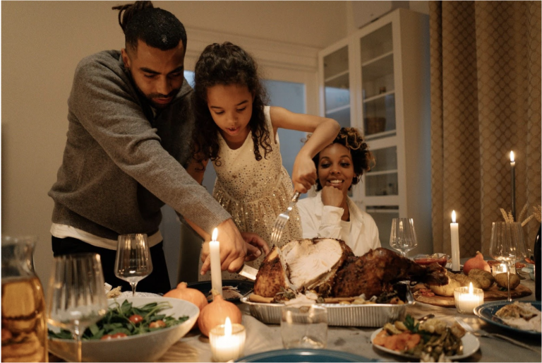 Image of a family carving their turkey on Thanksgiving and looking for ways to be mindful during this holiday season as a boost to their DBT therapy in Suffolk County NY.