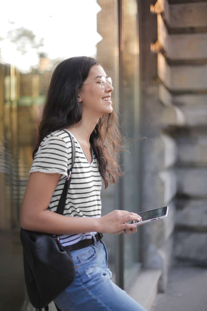 A photograph capturing the genuine joy and relief of a teenager after a successful therapy session. The image features a young person with a bright smile, their face beaming with happiness.