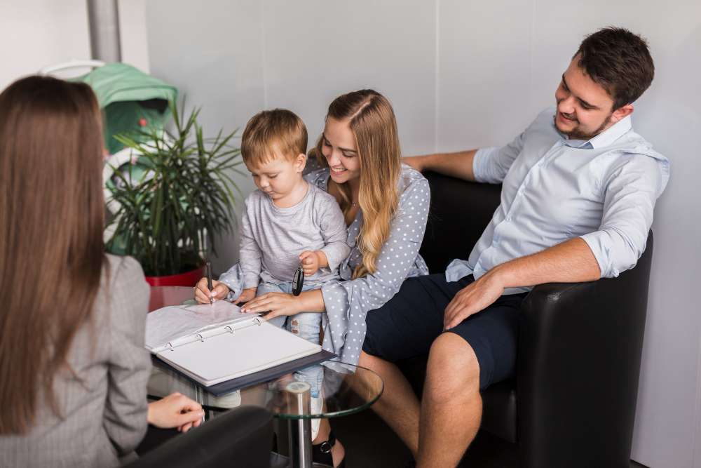 Parents and a young child engaging in a clinical screening